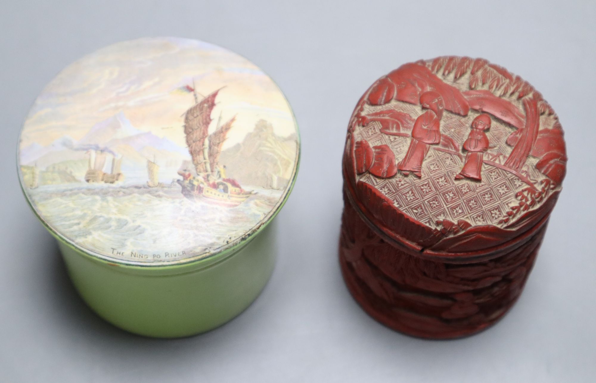 A Chinese cinnabar lacquer cylindrical box and cover carved with figures in gardens and a Ning Po River Prattware pot lid